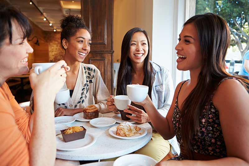 Group of women drinking coffee at a shop